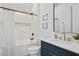 Modern bathroom with white tiled shower, marble countertop, and black fixtures and black framed mirror at 4633 W Lowell Ave, Tampa, FL 33629