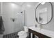 Modern bathroom featuring sleek shower, unique tiling, and vanity at 4633 W Lowell Ave, Tampa, FL 33629