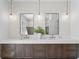 Elegant bathroom featuring a double vanity, modern fixtures, decorative mirrors and pendant lighting at 4633 W Lowell Ave, Tampa, FL 33629