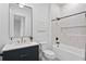Modern bathroom with white tiled shower, marble countertop, and black fixtures at 4633 W Lowell Ave, Tampa, FL 33629
