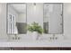 Elegant bathroom featuring a double vanity, modern fixtures, decorative mirrors and a vase of greenery at 4633 W Lowell Ave, Tampa, FL 33629