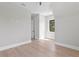 Bright bedroom with wood floors, one window, ceiling fan, and light gray walls and white trim at 4633 W Lowell Ave, Tampa, FL 33629
