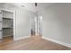 Bedroom featuring wood floors, closet, and ensuite bathroom with modern finishes and fixtures at 4633 W Lowell Ave, Tampa, FL 33629