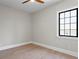 Bright bedroom featuring hardwood floors, a large window, and minimalist design, ideal for relaxation and comfort at 4633 W Lowell Ave, Tampa, FL 33629