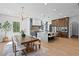 Open floor plan connects the dining room to a modern kitchen with a marble island and seating for casual dining at 4633 W Lowell Ave, Tampa, FL 33629