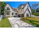 Beautiful two-story home showcasing a brick driveway and lush green lawn at 4633 W Lowell Ave, Tampa, FL 33629