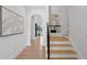 Bright foyer with hardwood floors, staircase, and arched entryways at 4633 W Lowell Ave, Tampa, FL 33629