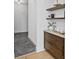Hallway featuring a built-in coffee bar with marble countertop and floating shelves at 4633 W Lowell Ave, Tampa, FL 33629
