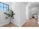 Hallway featuring hardwood floors and a decorative mirror in the distance at 4633 W Lowell Ave, Tampa, FL 33629