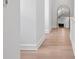 Bright hallway featuring hardwood floors and a decorative mirror in the distance at 4633 W Lowell Ave, Tampa, FL 33629