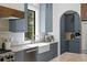 Modern kitchen with grey cabinets, a farmhouse sink, and stainless steel appliances at 4633 W Lowell Ave, Tampa, FL 33629