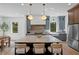 Spacious kitchen with a large marble island, stainless steel appliances, and modern lighting at 4633 W Lowell Ave, Tampa, FL 33629