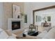 Bright living room features a stone fireplace and comfortable seating for relaxing and entertaining guests at 4633 W Lowell Ave, Tampa, FL 33629
