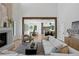 Inviting living space with a stone fireplace, wooden beam accents, and open access to the dining and kitchen areas at 4633 W Lowell Ave, Tampa, FL 33629
