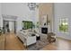 Spacious living room with a soaring ceiling, stone fireplace, and large windows creates an airy, light-filled space at 4633 W Lowell Ave, Tampa, FL 33629
