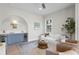 Stylish living room featuring a custom bar area with a blue cabinet and dual wine refrigerators at 4633 W Lowell Ave, Tampa, FL 33629