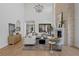 Bright living space with tall ceilings, stone fireplace, comfortable seating, and seamless access to the outdoor space at 4633 W Lowell Ave, Tampa, FL 33629