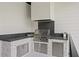 Outdoor kitchen with stainless steel grill, stone accents, and plenty of counter space at 4633 W Lowell Ave, Tampa, FL 33629