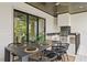 Covered outdoor dining area with seating for eight and a built-in grill at 4633 W Lowell Ave, Tampa, FL 33629