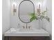 Elegant powder room with a modern mirror, stylish sconces, and a vessel sink at 4633 W Lowell Ave, Tampa, FL 33629