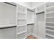 Walk-in closet with white shelving units and racks at 4633 W Lowell Ave, Tampa, FL 33629