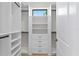 Bright walk-in closet with custom shelving, drawers, and a window offering a view of the outdoors at 4633 W Lowell Ave, Tampa, FL 33629
