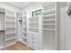 Spacious walk-in closet featuring custom shelving and ample storage space with a window for natural light at 4633 W Lowell Ave, Tampa, FL 33629