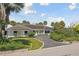 Single-story home with a large driveway and manicured lawn at 5031 W San Miguel St, Tampa, FL 33629