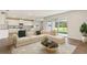 Open living room with sectional sofa and view of kitchen at 10573 Bridgegate Heights Loop, San Antonio, FL 33576