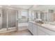 Elegant bathroom with double vanity, soaking tub, and walk-in shower at 10573 Bridgegate Heights Loop, San Antonio, FL 33576