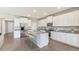Modern kitchen with white cabinets, granite counters, and island at 10573 Bridgegate Heights Loop, San Antonio, FL 33576