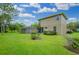 Expansive backyard with a screened-in pool and lush lawn at 10645 Plantation Bay Dr, Tampa, FL 33647