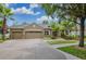 House exterior showcasing a three-car garage and landscaping at 10645 Plantation Bay Dr, Tampa, FL 33647
