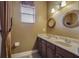Double vanity bathroom with two sinks, large mirrors, and window at 10645 Plantation Bay Dr, Tampa, FL 33647