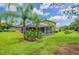 Backyard oasis with screened-in pool and lush landscaping at 10645 Plantation Bay Dr, Tampa, FL 33647