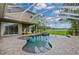 Resort-style pool with covered patio overlooking a golf course at 10645 Plantation Bay Dr, Tampa, FL 33647