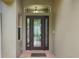 Front door with stained glass detailing and brick flooring at 10645 Plantation Bay Dr, Tampa, FL 33647