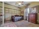 Bedroom with daybed, dresser, and wood flooring at 10645 Plantation Bay Dr, Tampa, FL 33647