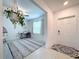 Bright and airy entryway with a decorative rug and hanging plant at 11711 Lavender Loop, Spring Hill, FL 34609