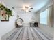 Bright bedroom with a ceiling fan, patterned rug, and plenty of natural light at 11711 Lavender Loop, Spring Hill, FL 34609