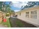 Side yard with wooden fence, and a view of the backyard at 1505 Cedar St, Safety Harbor, FL 34695