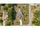 Overhead view of a large backyard featuring pool, trampoline and fenced yard at 15272 Spinning Wheel Ln, Brooksville, FL 34604