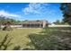 Fenced backyard features a pool, patio, playset, and large area for various outdoor activities at 15272 Spinning Wheel Ln, Brooksville, FL 34604