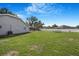 The backyard features a fenced perimeter, a trampoline, and lush green space for outdoor enjoyment at 15272 Spinning Wheel Ln, Brooksville, FL 34604