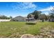 Large, fenced backyard with plenty of green space and a storage shed for outdoor recreation at 15272 Spinning Wheel Ln, Brooksville, FL 34604