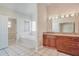 Bathroom with a soaking tub and a granite-topped vanity at 15272 Spinning Wheel Ln, Brooksville, FL 34604
