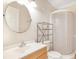 Modern bathroom featuring a glass-enclosed shower, a round mirror, and a stylish vanity for a clean look at 15272 Spinning Wheel Ln, Brooksville, FL 34604