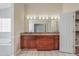 Bathroom featuring a vanity with double sinks and a walk-in closet at 15272 Spinning Wheel Ln, Brooksville, FL 34604