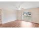 Bright bedroom featuring a large window and laminate wood flooring at 15272 Spinning Wheel Ln, Brooksville, FL 34604