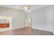 Spacious bedroom with wood floors, ceiling fan, and ensuite bathroom at 15272 Spinning Wheel Ln, Brooksville, FL 34604